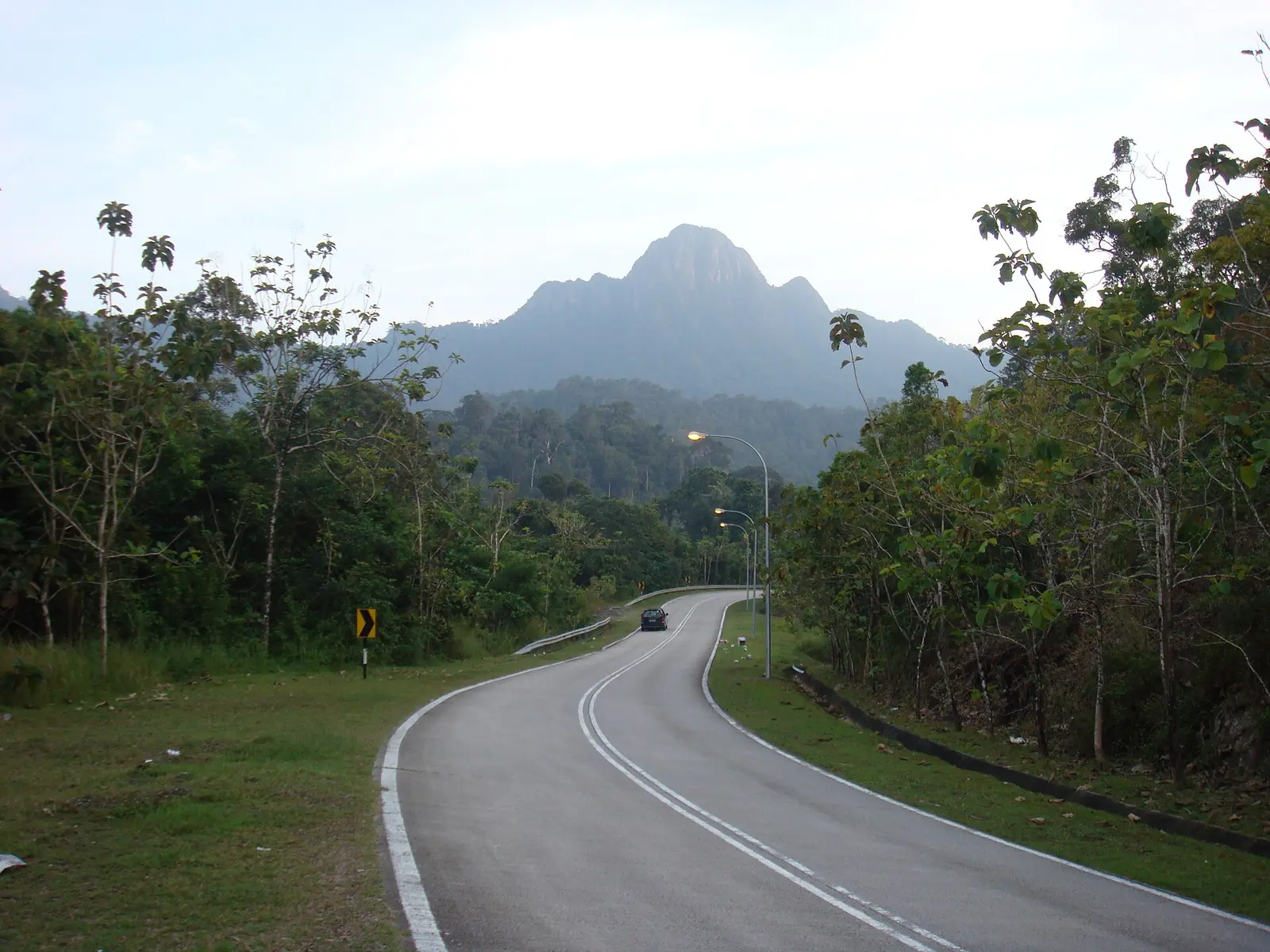 Winding road on Langkawi island toward Datai Bay with mountains behind
