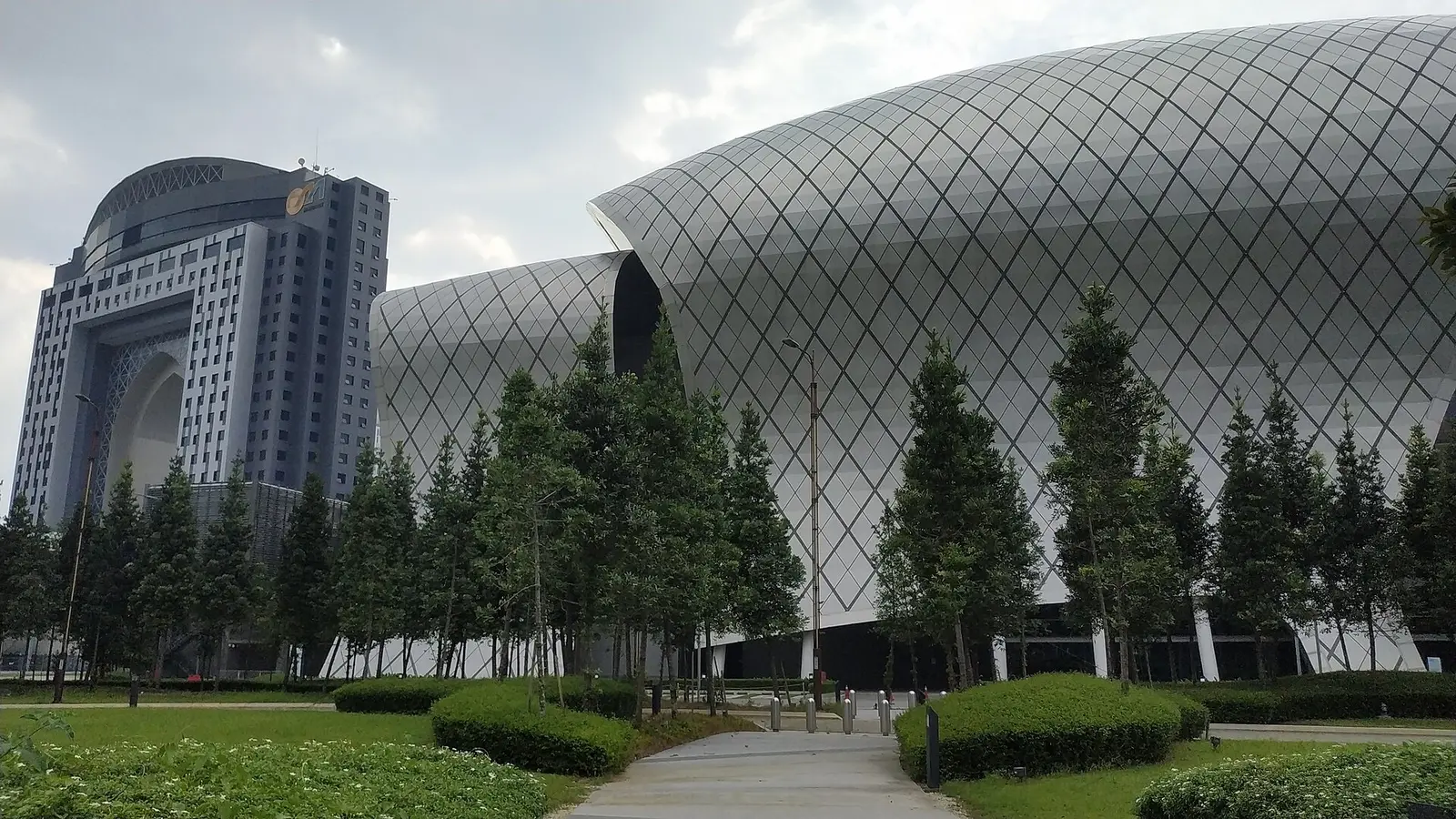 Exterior of the Malaysia International Trade and Exhibition Centre seen across trees