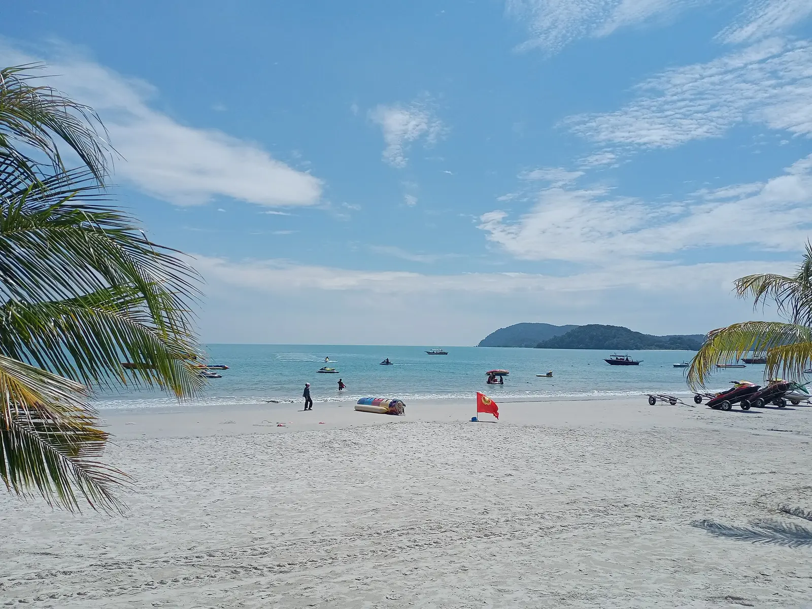 White sand beach and palm trees at Pantai Cenang, Langkawi
